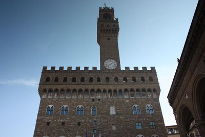 Low angle view of clock tower against sky