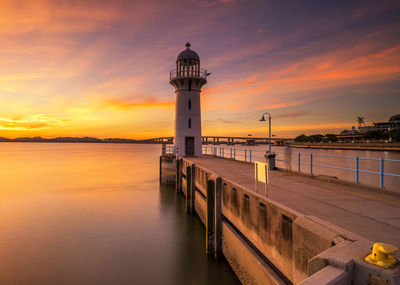 Lighthouse at seaside during sunset