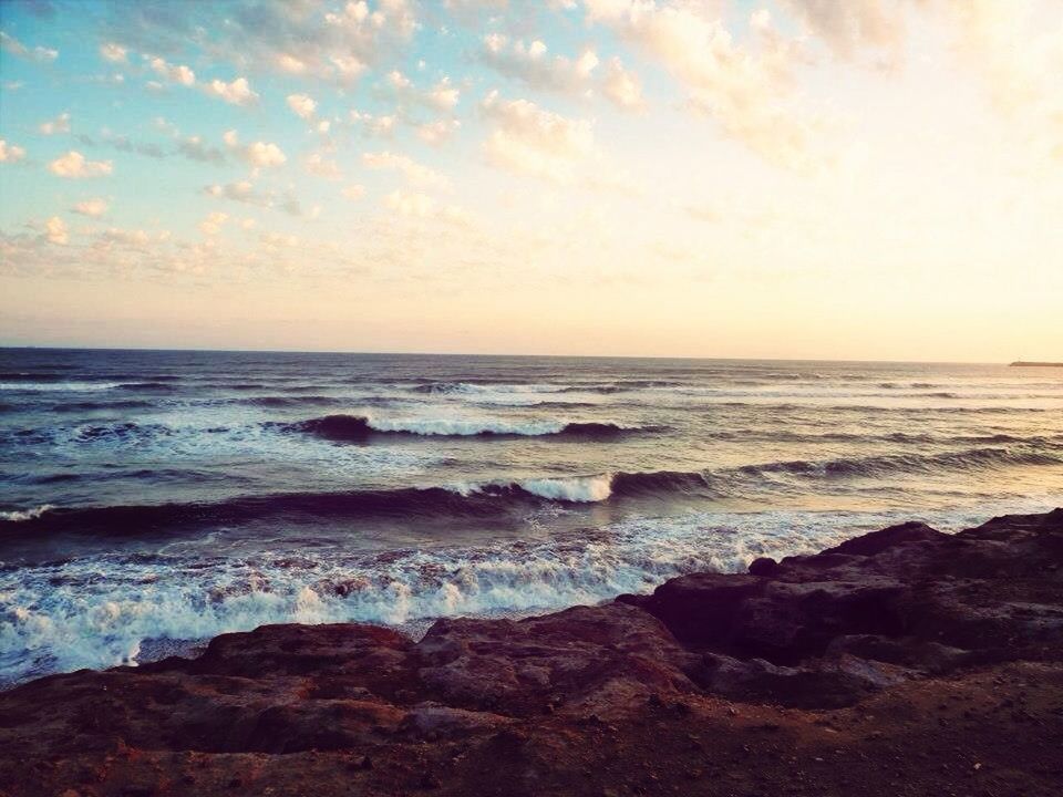 sea, horizon over water, water, scenics, beach, beauty in nature, wave, sky, tranquil scene, shore, tranquility, sunset, surf, nature, rock - object, idyllic, rock formation, cloud - sky, outdoors, remote