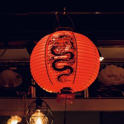 Low angle view of illuminated lanterns hanging on ceiling