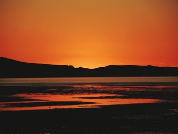 Scenic view of lake at sunset