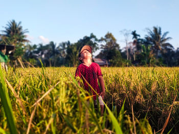 Young woman standing on field