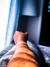 Low section of man relaxing on window