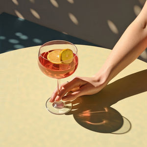 Midsection of woman holding wineglass