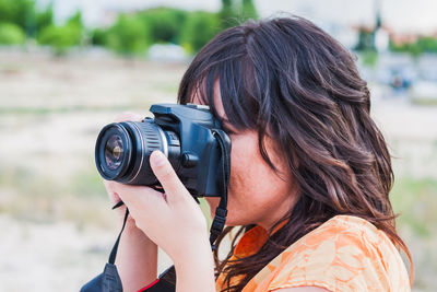 Close-up portrait of woman photographing