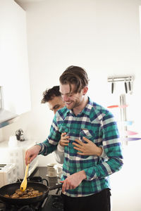 Young man and woman standing at home