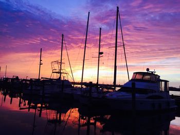 Boats in harbor at sunset