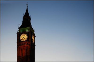 Low angle view of clock tower against clear sky