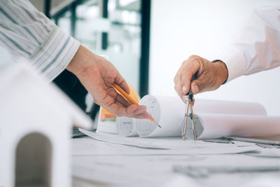 Midsection of man working on table