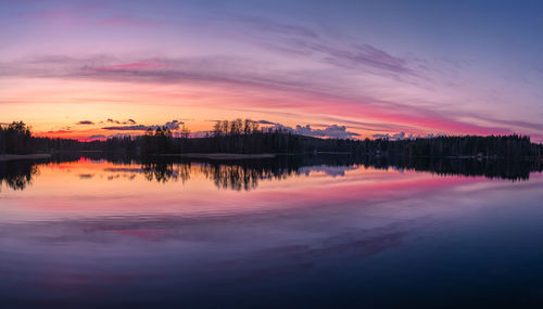 Scenic view of lake against romantic sky at sunset