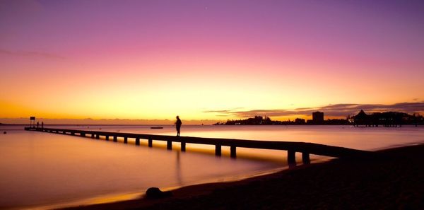 Scenic view of sea against romantic sky at sunset