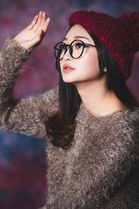 Beautiful woman looking away while wearing hat