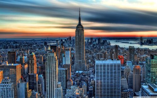 Aerial view of cityscape against sky during sunset