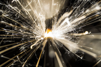 Close-up of illuminated fireworks against sky at night