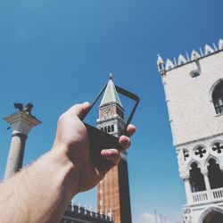 Low angle view of bell tower against blue sky