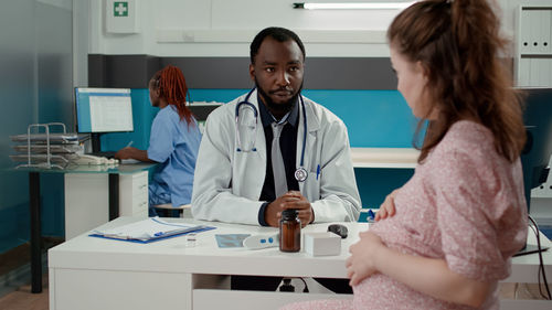 Female doctor examining chemical in clinic