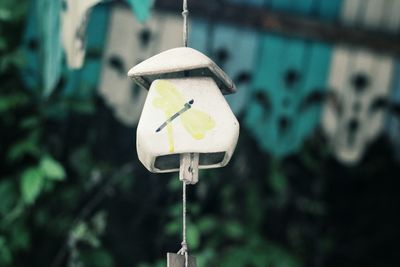 Close-up of electric lamp hanging on pole