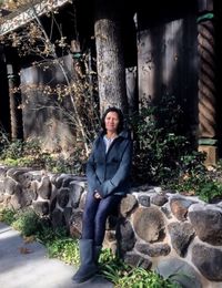 Portrait of a smiling young man sitting on rock