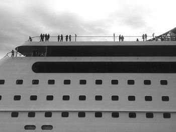 Low angle view of people on cruise ship against sky