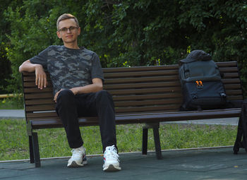 Man sitting on bench in park