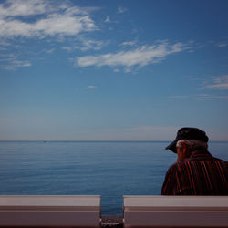 Man in sea against sky