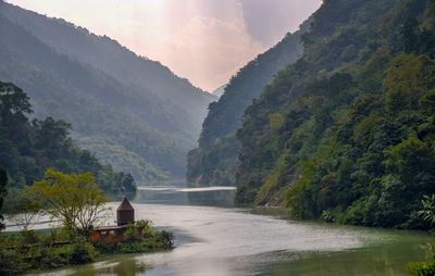 Scenic view of river amidst mountains against sky