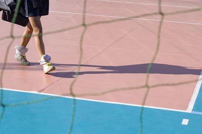 Low section of woman on tennis court