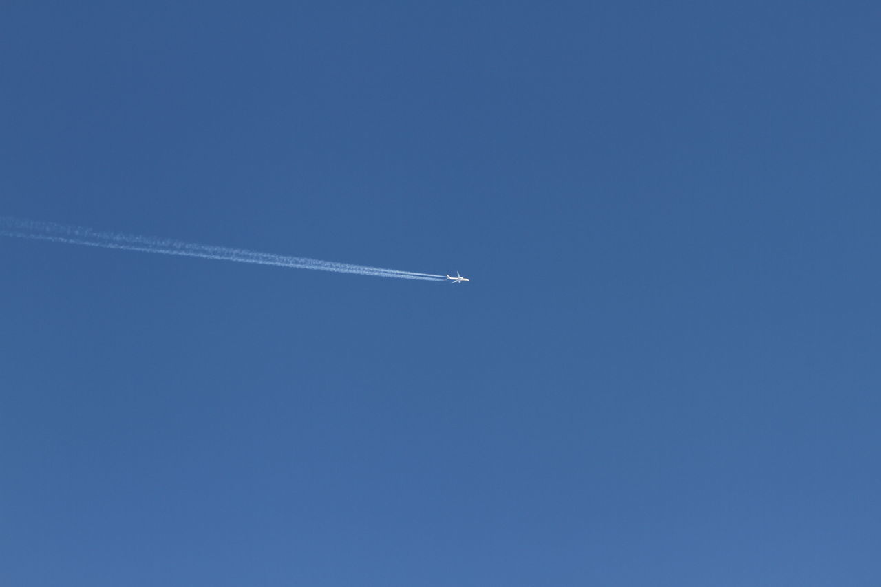 LOW ANGLE VIEW OF AIRPLANE FLYING IN SKY