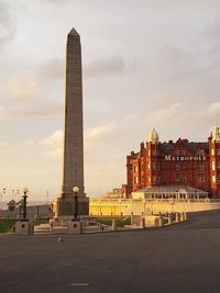 Historic buildings in city against sky during sunset