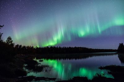 Scenic view of lake against sky at night