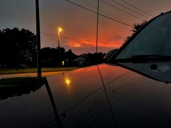 Cars on road at sunset