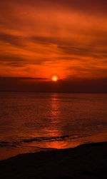 Scenic view of sea against romantic sky at sunset