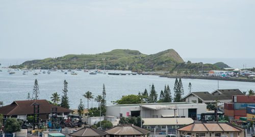 High angle view of town by sea against sky