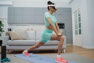 Portrait of young woman exercising in gym