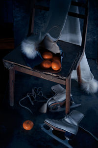 Oranges on chair by shoes