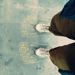 Low section of man standing on tiled floor