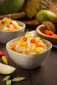 Close-up of food in bowls on wooden table