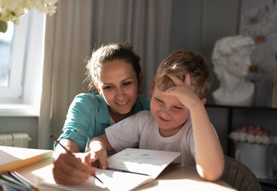 Mother and son drawing on weekend day