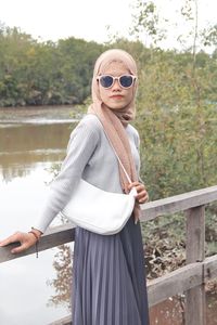 Young woman wearing sunglasses standing outdoors