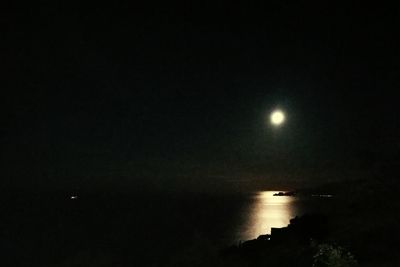 Scenic view of sea against clear sky at night