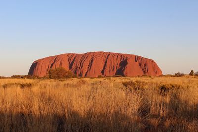 Scenic view of rocks on field against clear sky