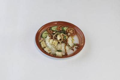 Directly above shot of food in bowl on white background