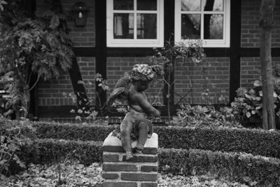 Man statue against building