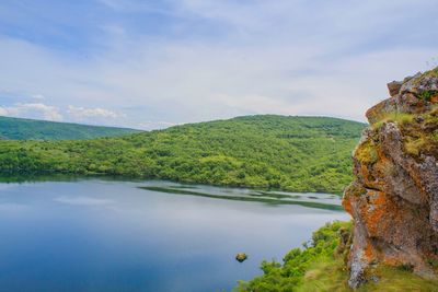 Scenic view of lake and mountains against sky