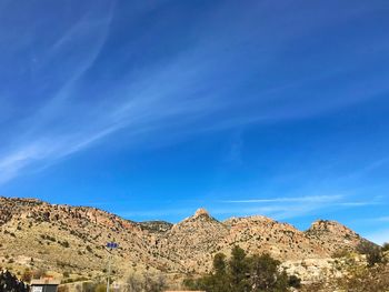 Scenic view of mountains against blue sky