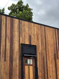Low angle view of text on building against sky