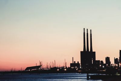 Silhouette of building against sky during sunset