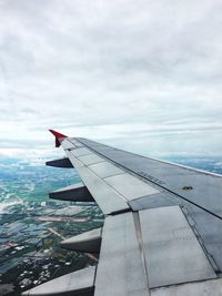 Close-up of airplane wing against sky