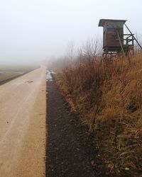 Road amidst trees against clear sky