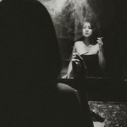 Rear view of woman smoking cigarette